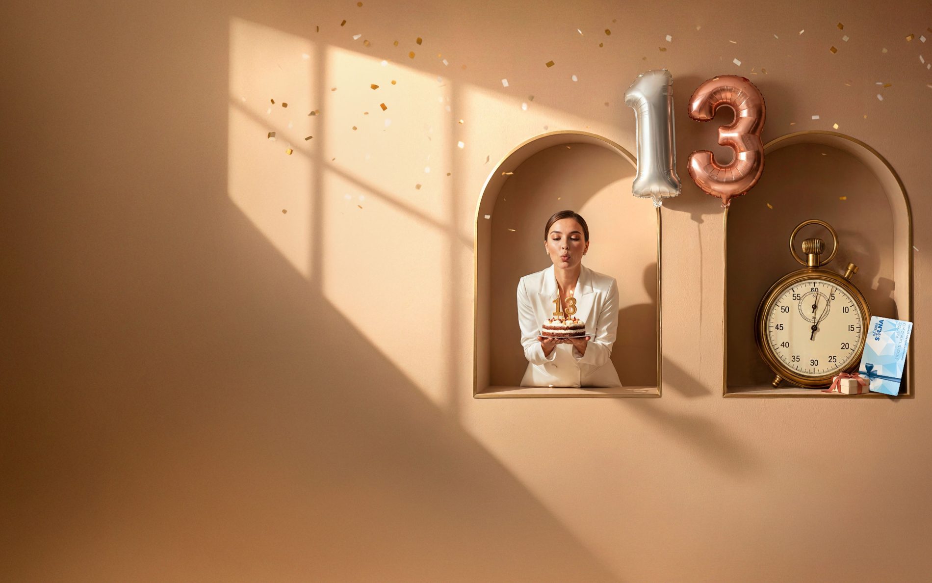 Kobieta z tortem urodzinowym i balony z liczbą 13 promujące akcję Szczęśliwa 13-tka w Galerii Solnej.