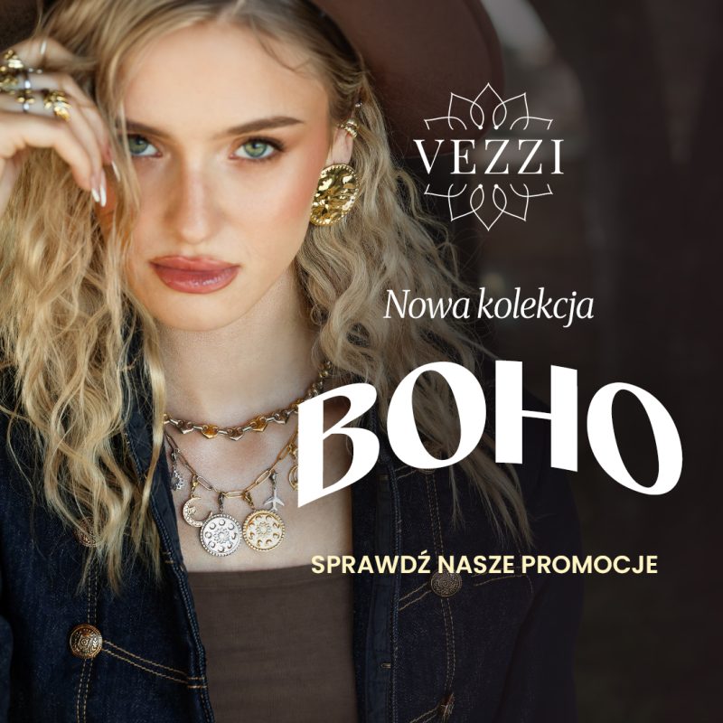 Baner wizerunkowo-promocyjny marki VEZZI przedstawiający blondynkę w kapeluszu i dżinsowej kurtce, prezentującą złotą biżuterię: efektowne kolczyki, liczne pierścionki oraz warstwowe naszyjniki z zawieszkami. W prawej części obrazu umieszczono białe logo „VEZZI”, napis „Nowa kolekcja”, duży nagłówek „BOHO” oraz wezwanie do działania „SPRAWDŹ NASZE PROMOCJE”.